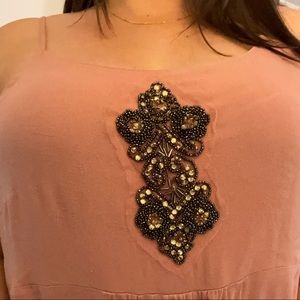 Pale pink dressy tank with jewel detail.